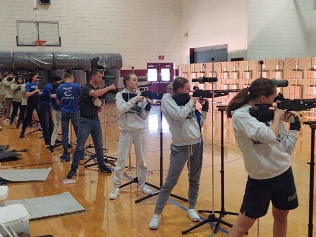 Nease air rifle team members perform the standing shooting portion of the competition.